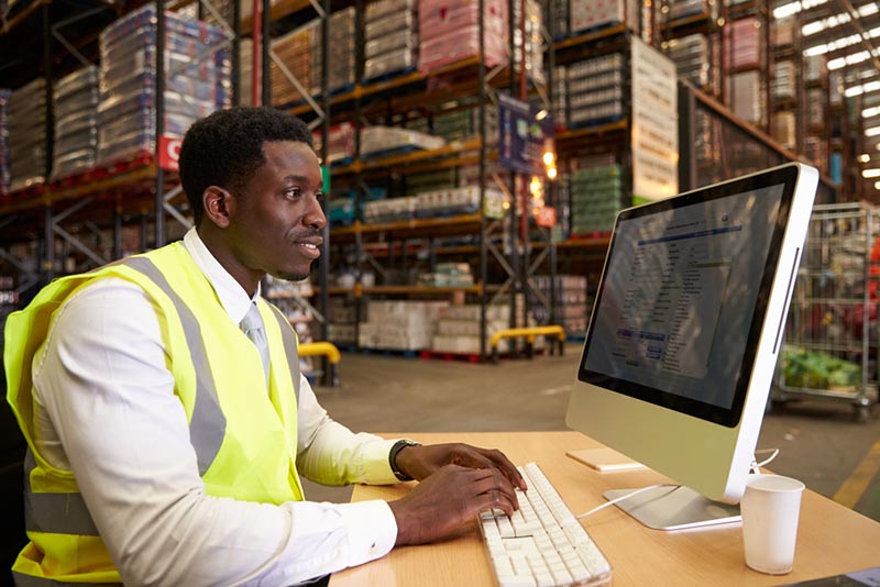 Warehouse worker at computer